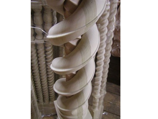 Custom twisted wooden newel post featuring a larger twist over a smaller twist for an intricate staircase design.